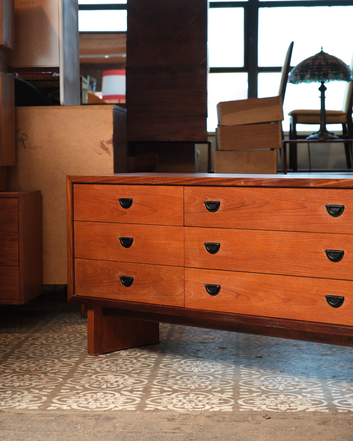 Front left corner detail of the dresser showing drawer joinery and angled leg.