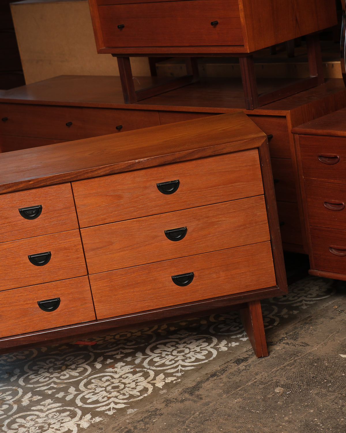 Close-up of the right side drawers and top corner showing wood grain and hardware detail.