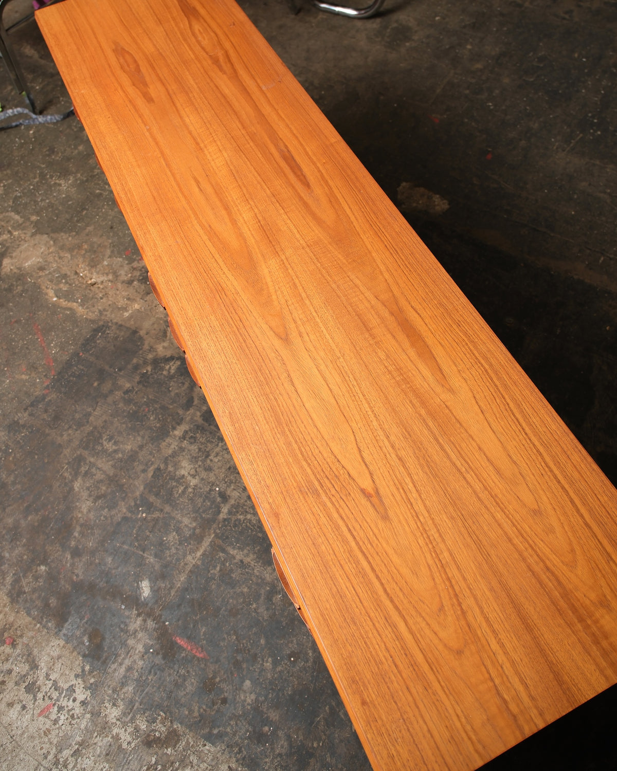 Overhead view of the teak dresser top showing the natural grain and finish.