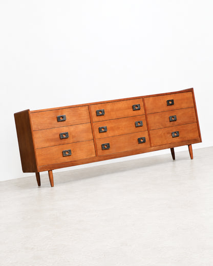 Side angle view of the dresser highlighting the case construction and wood grain.