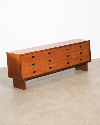 Detail view of the dresser's drawer pulls and wood joinery.