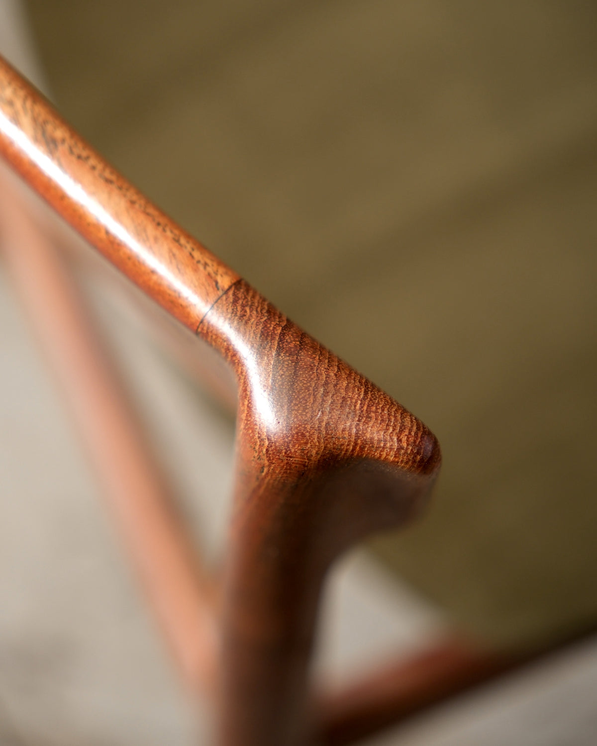 Detail of chair backrest joint showing teak grain and craftsmanship