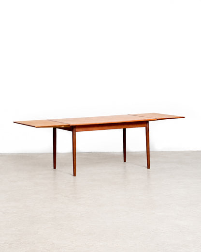 View of the table from the end showing the tapered leg profile and apron.