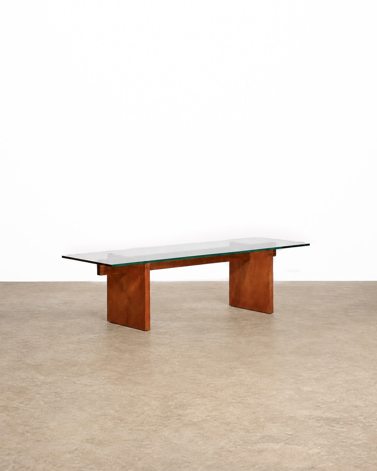 Mid-century modern teak glass coffee table on a plain white background — warm teak frame and clean mid-century lines