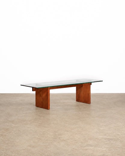 Mid-century modern teak glass coffee table on a plain white background — warm teak frame and clean mid-century lines