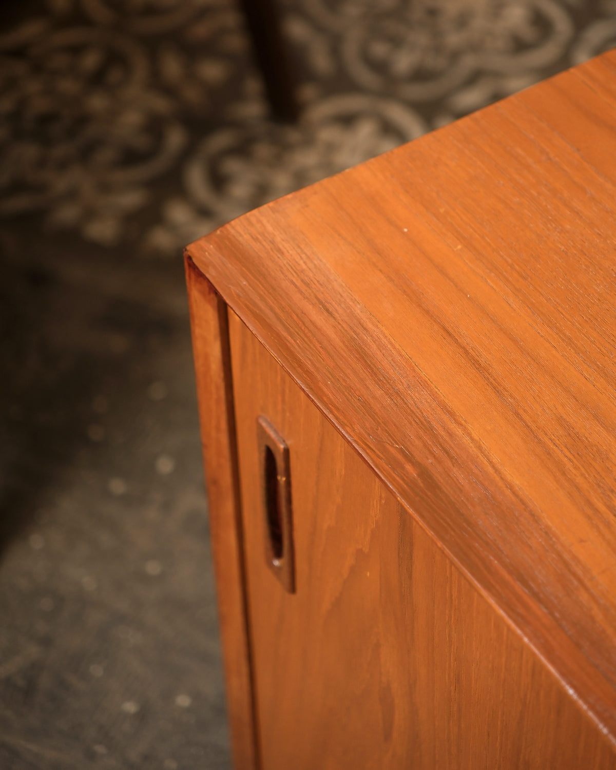 Close-up of the top corner and sliding door pull showing joinery and grain detail