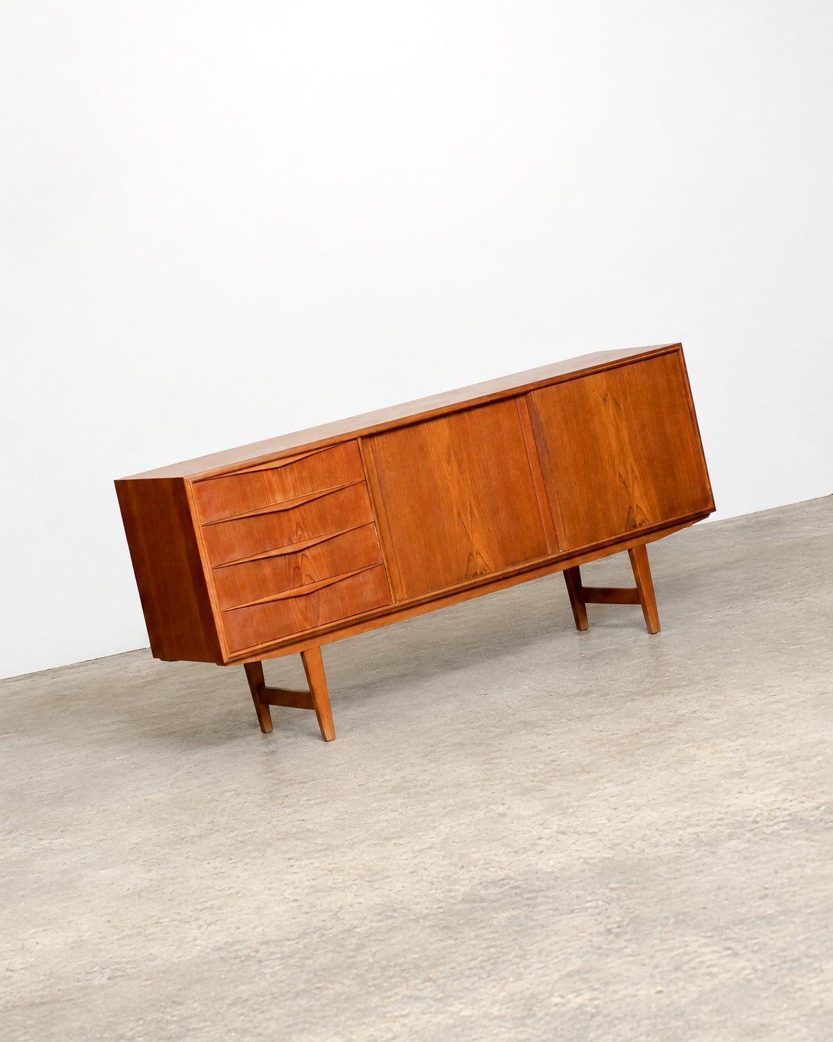 Full front angled view of the teak sideboard against a plain white backdrop.
