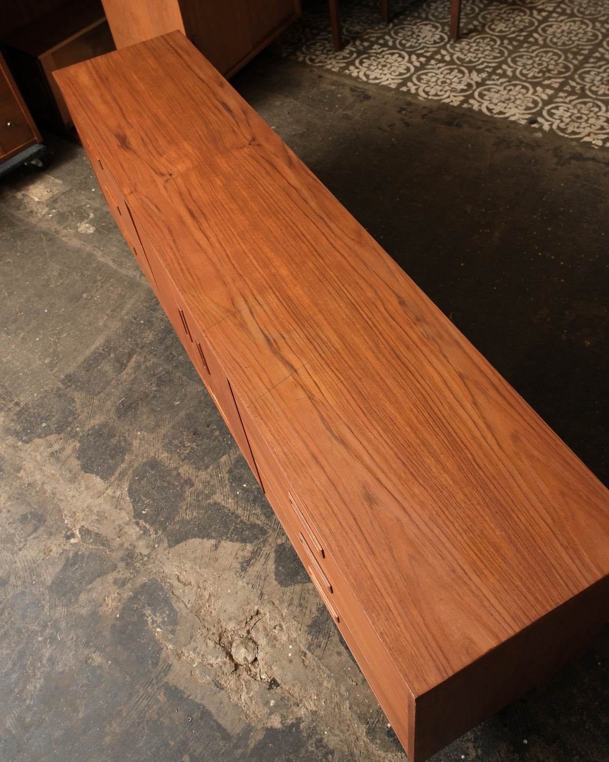 Overhead view of the sideboard top showing natural teak wood grain and finish.