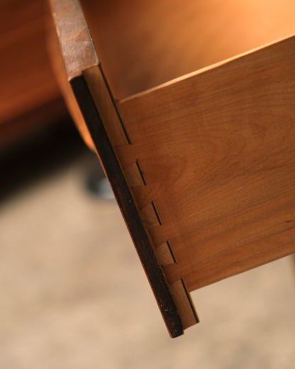 Close-up of dovetail joinery on a drawer of the mid-century modern walnut dresser
