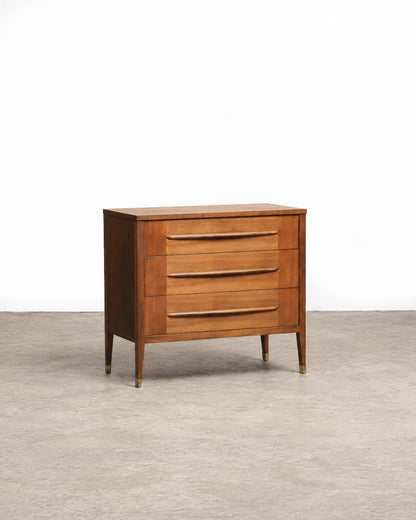 Front angled view of the walnut 3-drawer dresser with tapered legs and brass feet