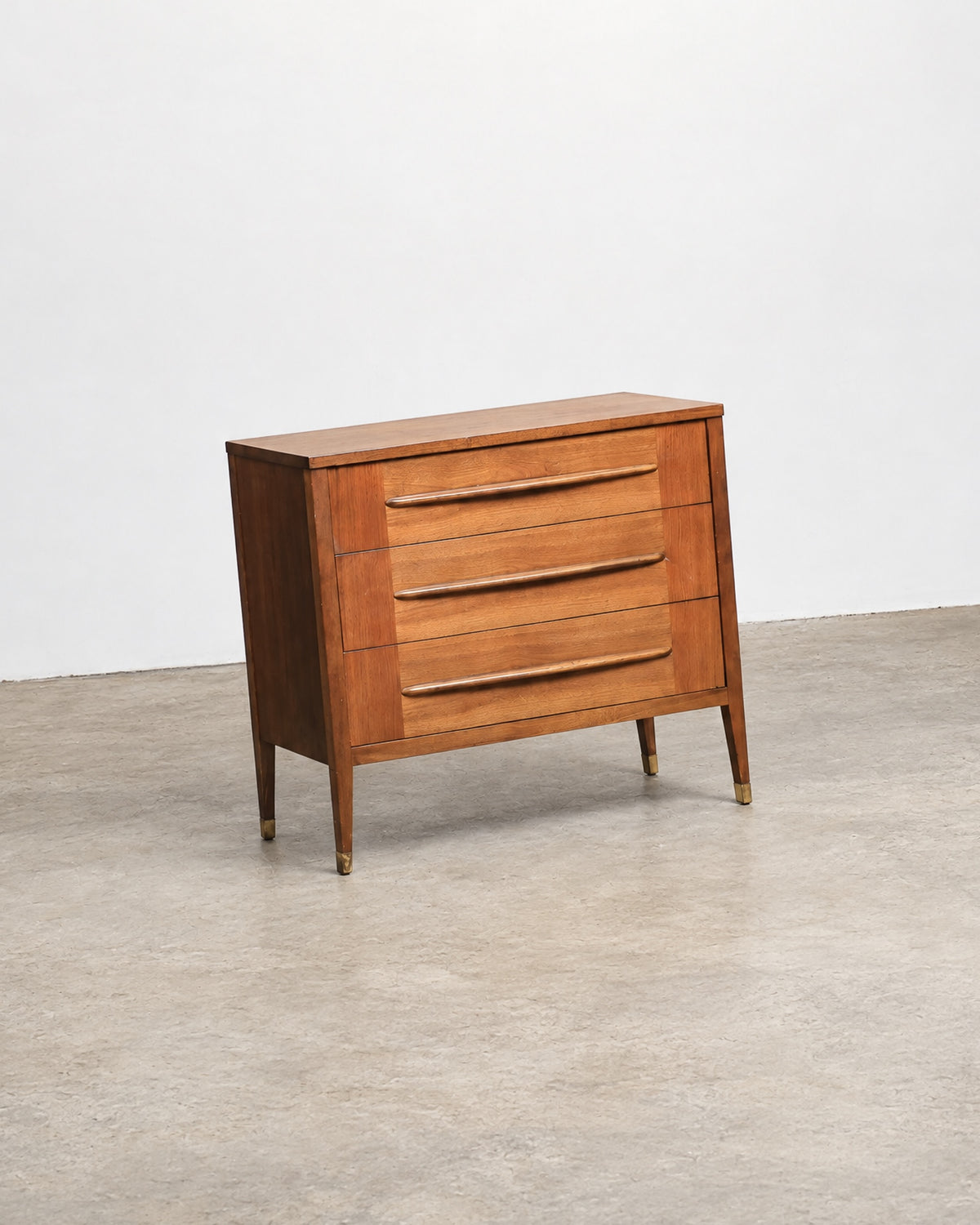 Side view of the walnut dresser showing profile and leg tapering
