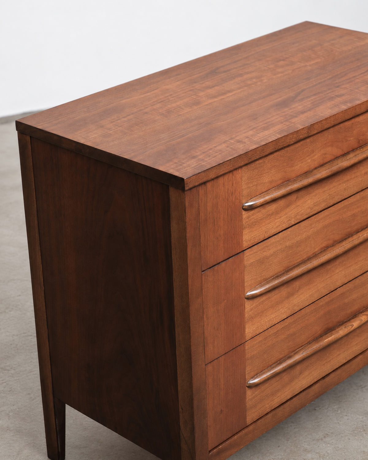 Full front view of the mid-century modern walnut 3-drawer dresser