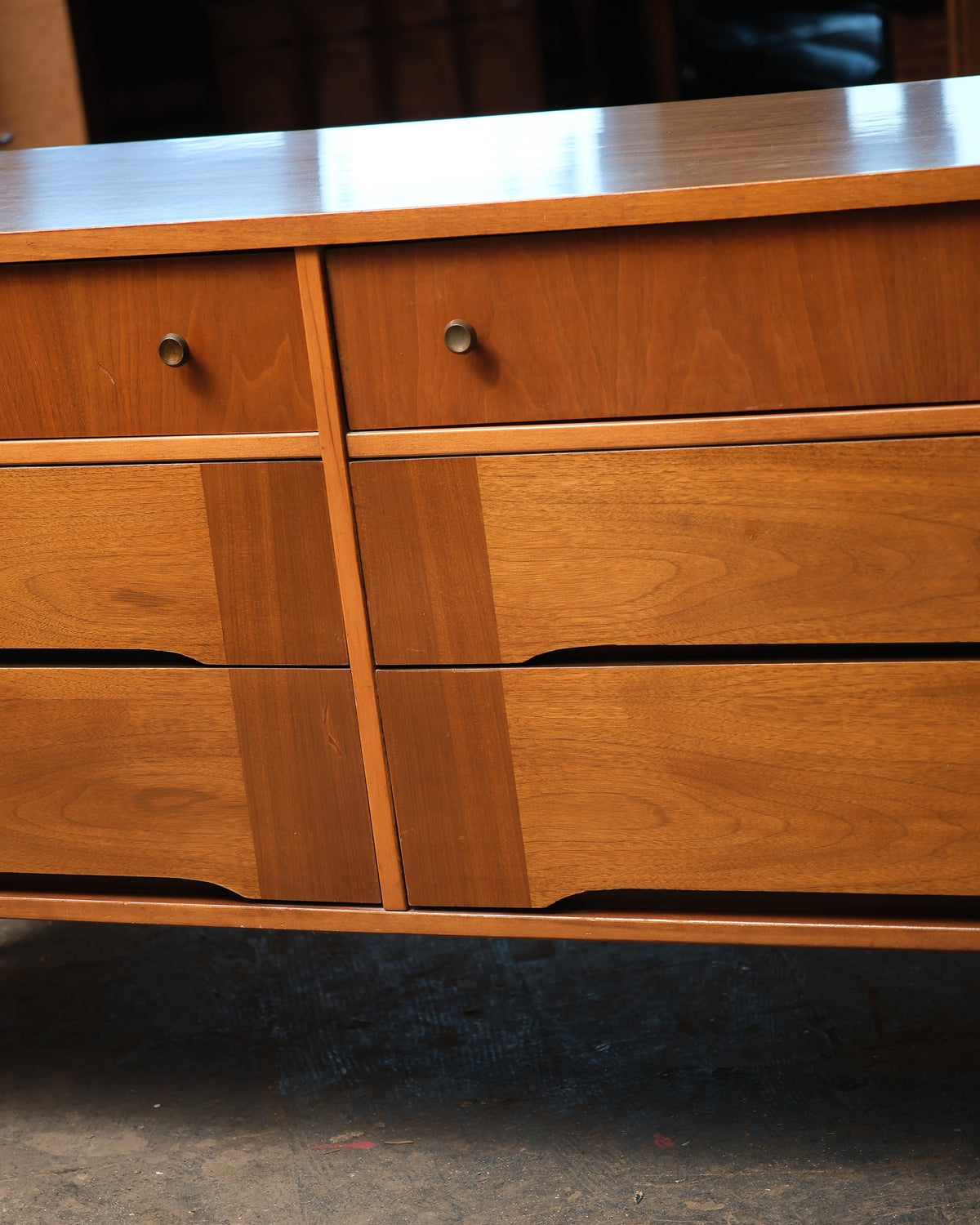Close-up of the two right-hand drawer pulls and the sculpted drawer front detail.