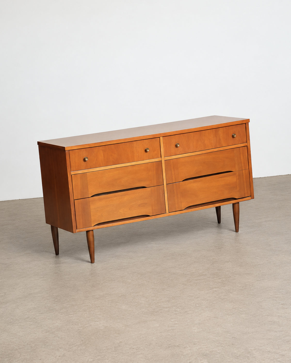 Detail of the top surface showing the walnut veneer grain pattern.