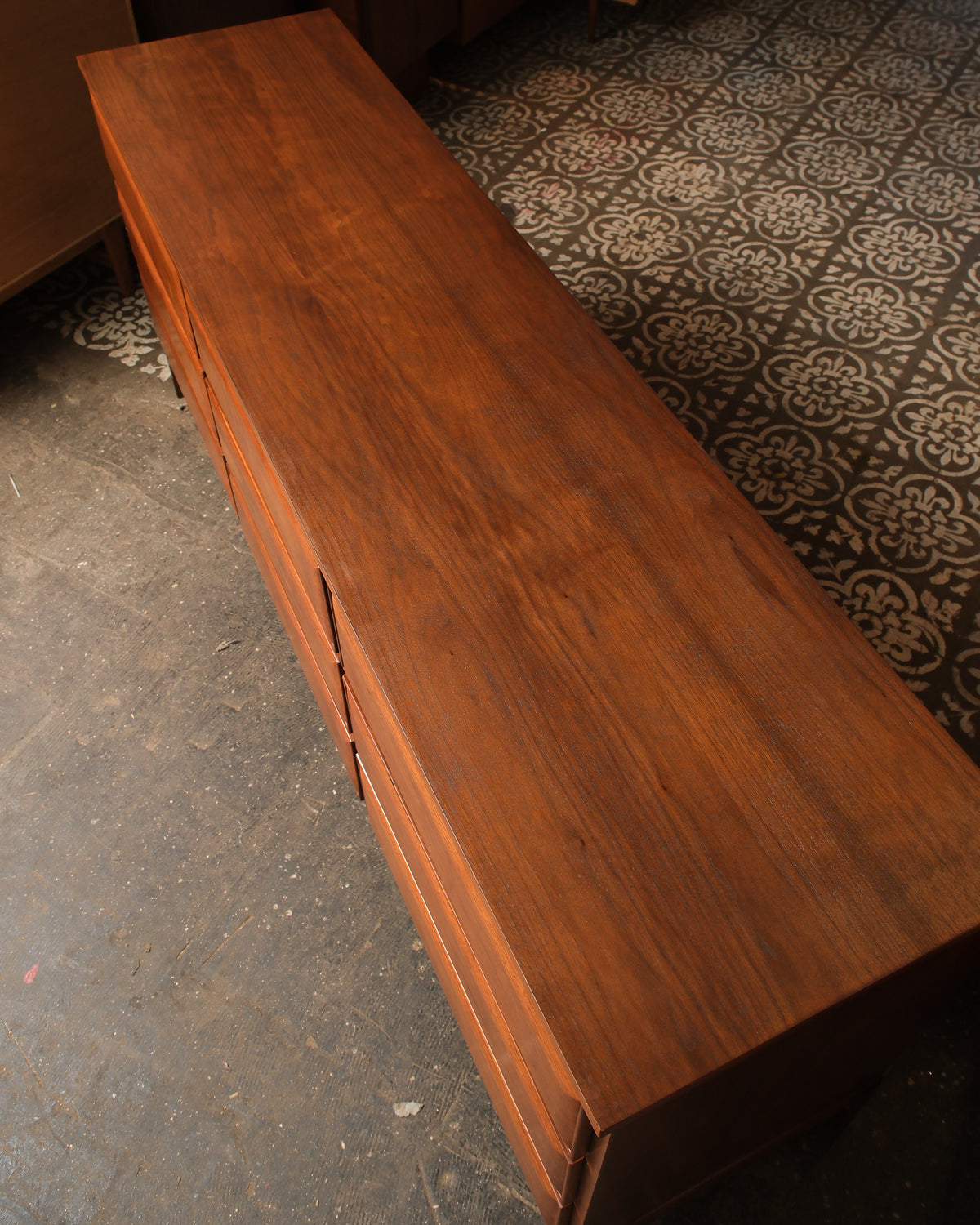 Overhead view of the dresser top showing the natural walnut wood grain pattern.