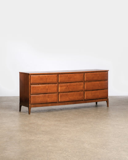 Side profile view showing the depth and tapered leg design of the dresser.