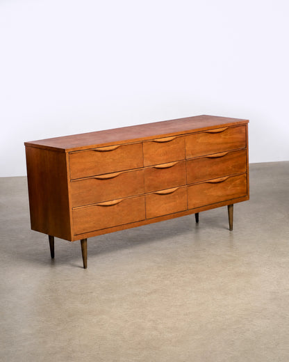 View of the dresser's side panel showing walnut veneer grain pattern.