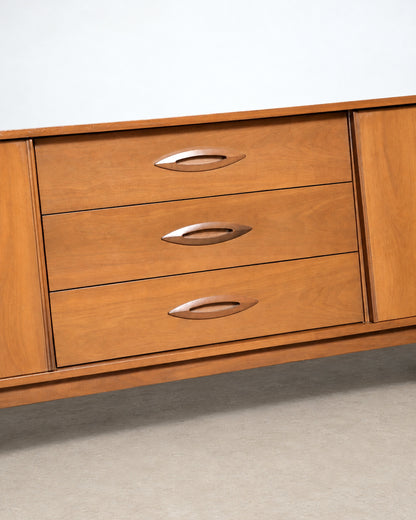 Wide shot of the dresser in the showroom among other vintage furniture.