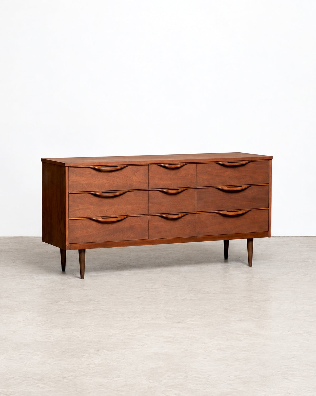 Front angled view of the full 9-drawer dresser on tapered legs against a white backdrop