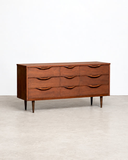 Front angled view of the full 9-drawer dresser on tapered legs against a white backdrop