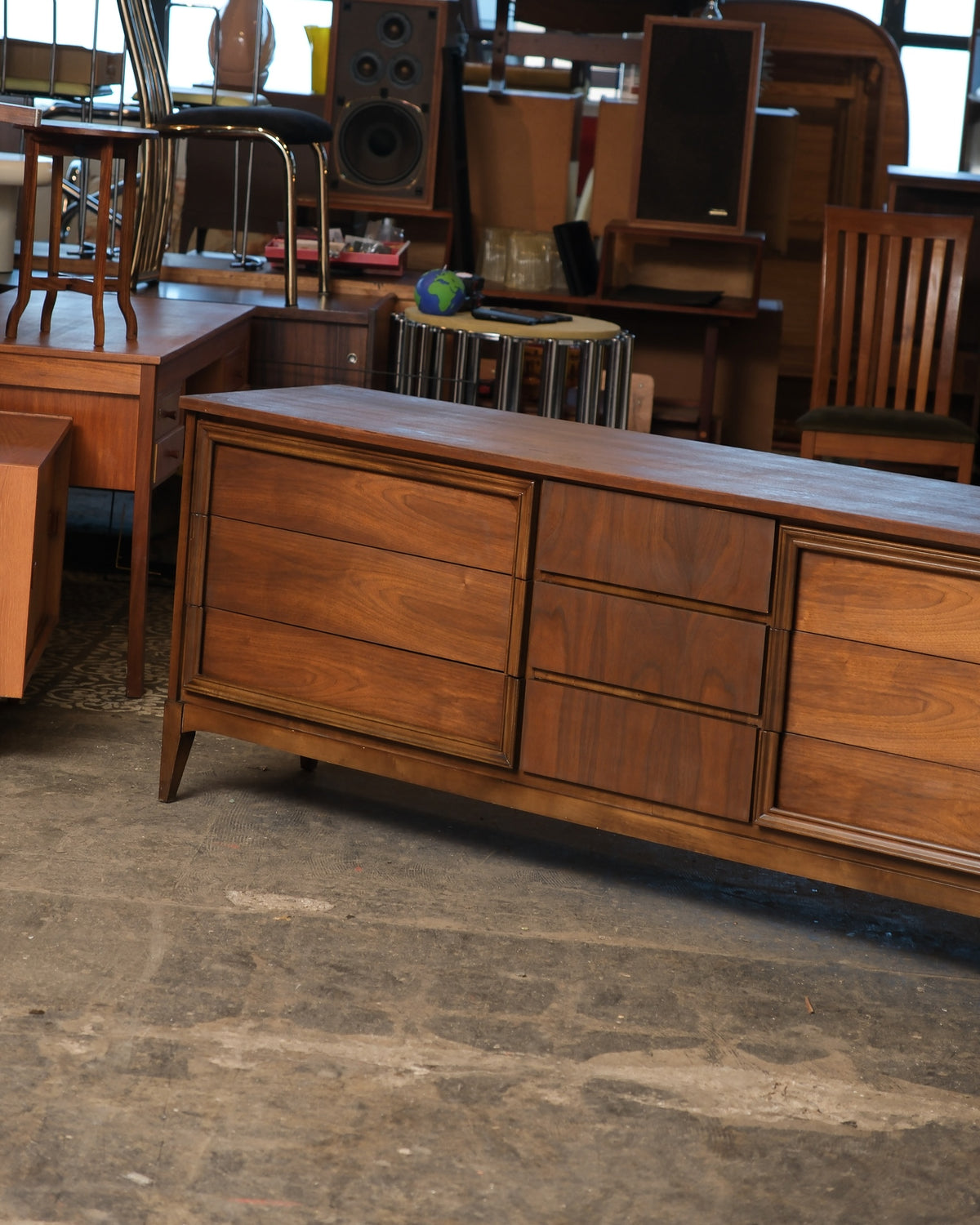 Full view of the dresser in the warehouse showing all nine drawers and overall proportions.