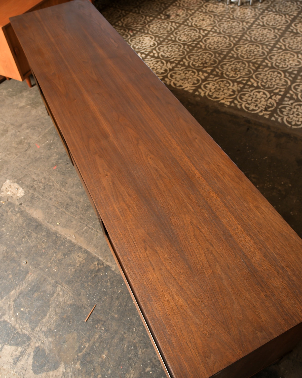 Overhead view of the walnut top showing the grain pattern running the length of the piece.