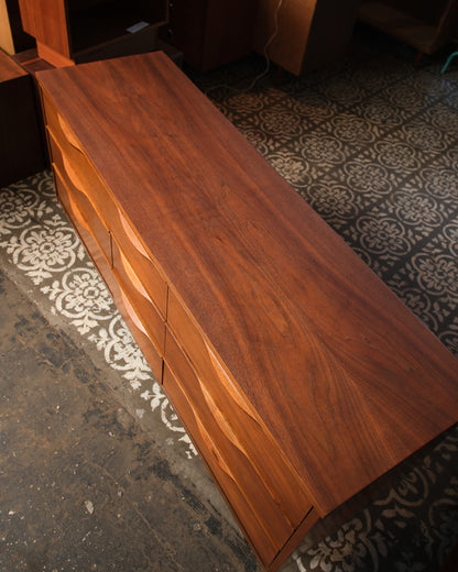 Top-down angled view of the dresser showing the walnut top grain and drawer arrangement.