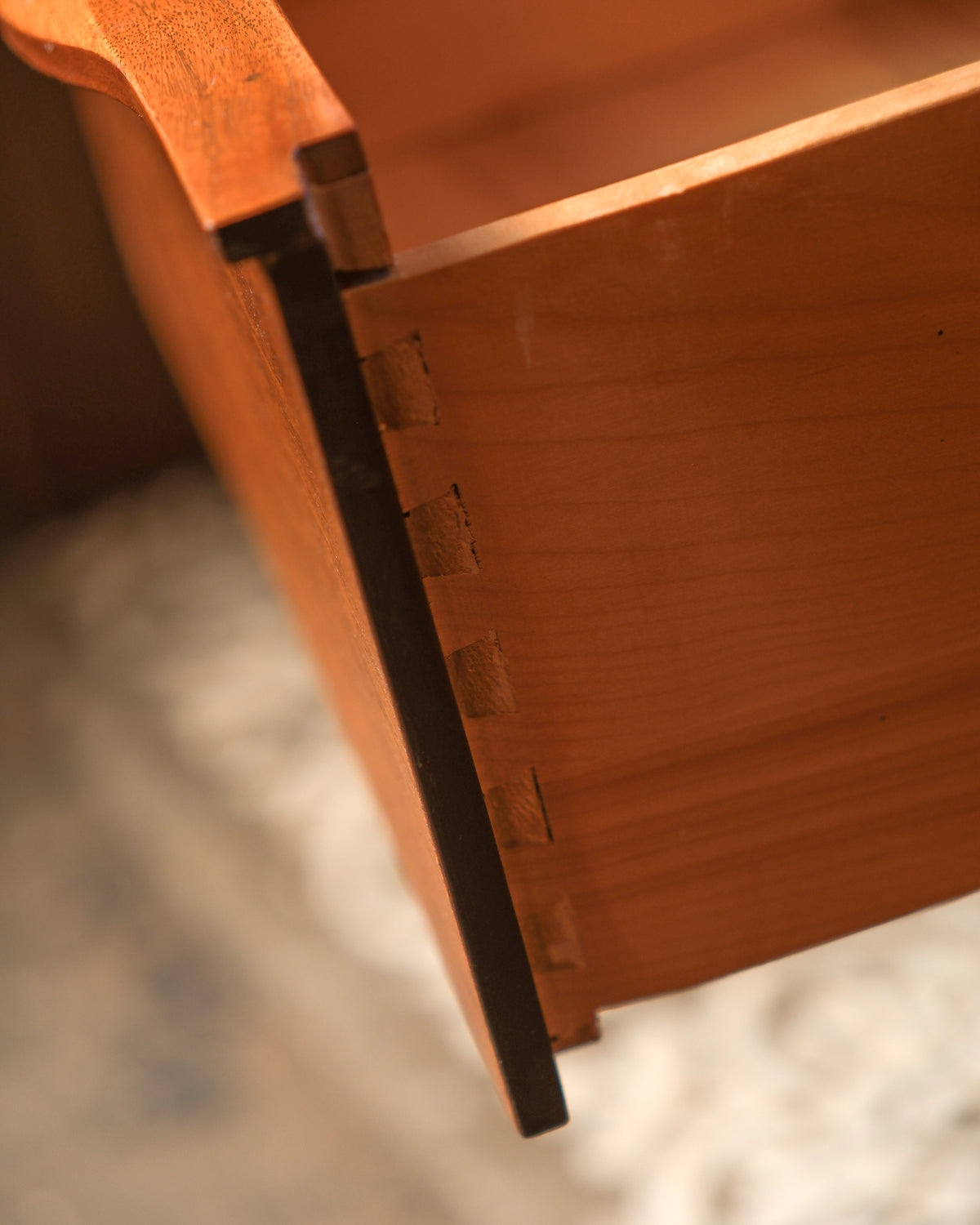 Three-quarter view of the dresser highlighting its tapered legs and low profile.