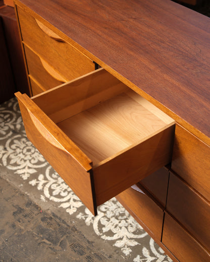 Close-up of a single drawer pull showing the sculpted wood detail.