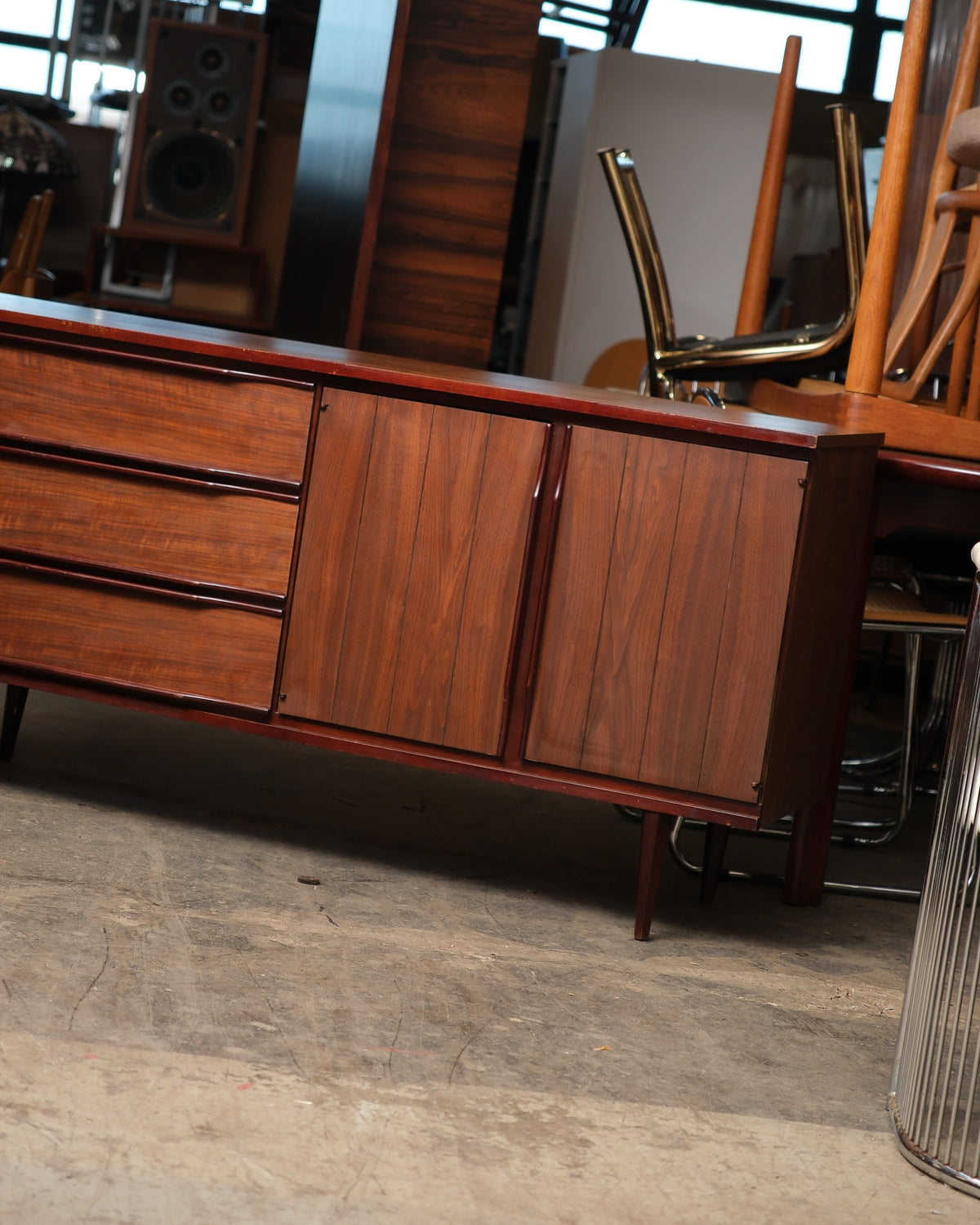 Close-up of the credenza's drawer fronts and paneled doors showing wood grain detail