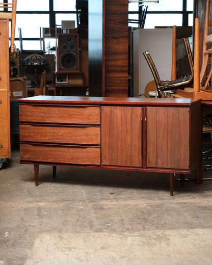 Straight-on front view of the walnut credenza on tapered legs