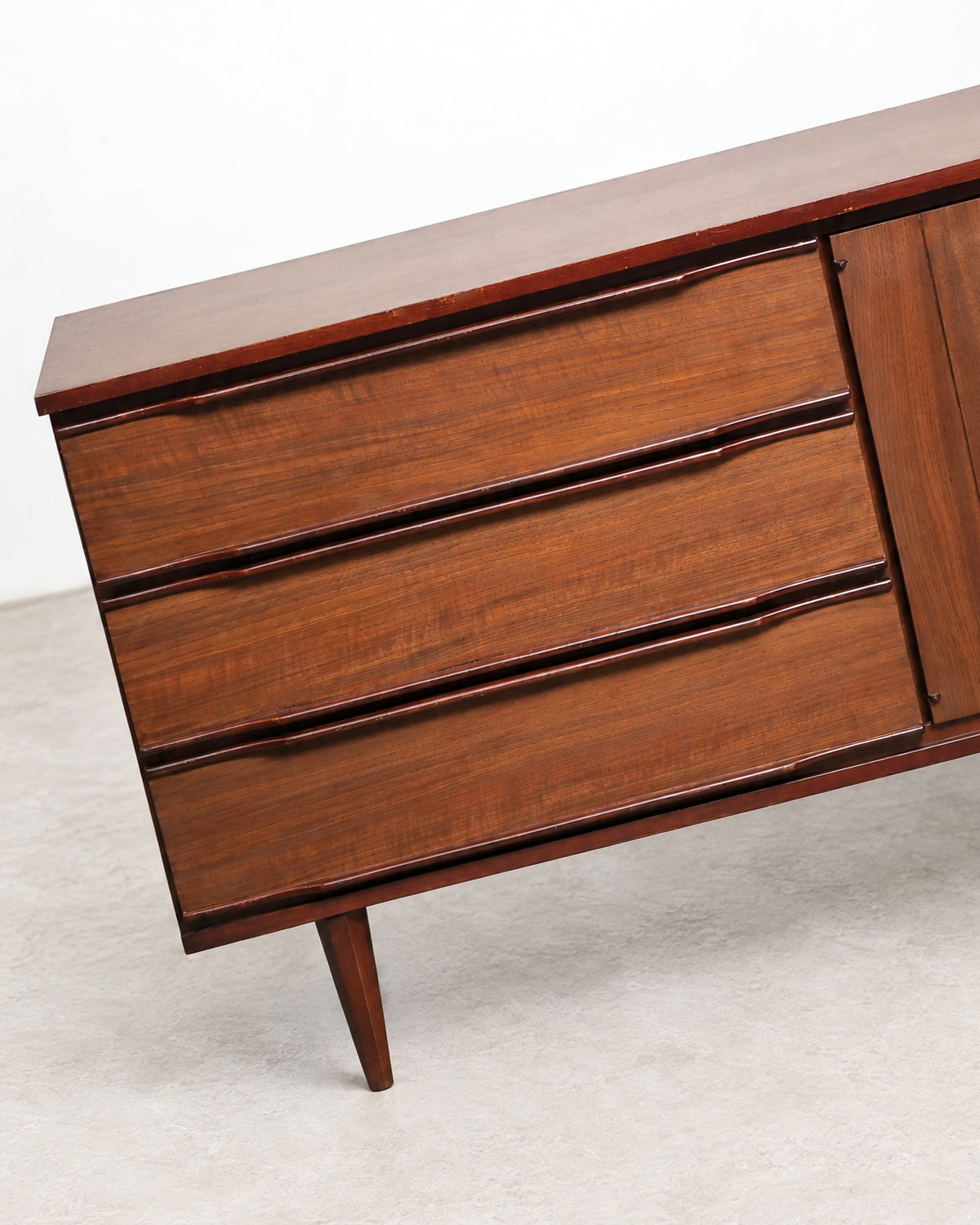 Side angle view of the credenza showing depth and tapered leg design