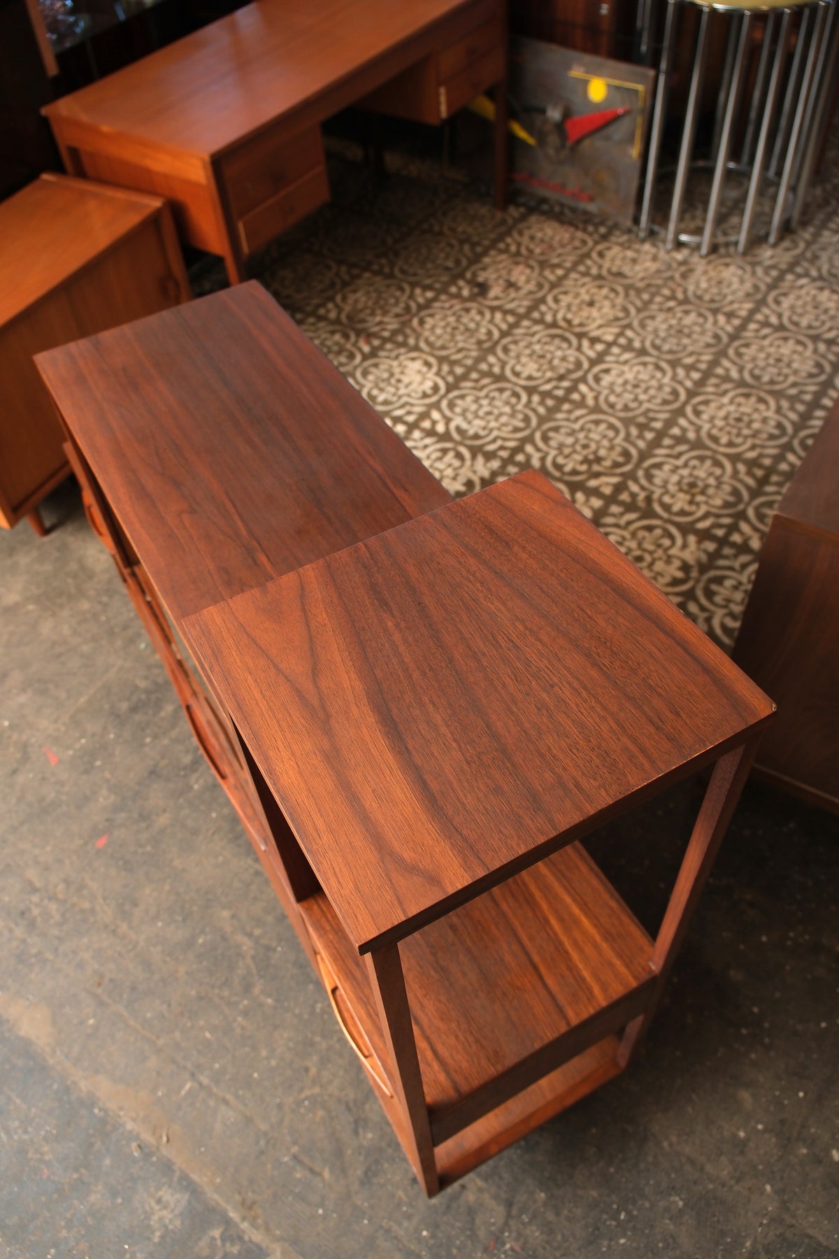 Overhead view showing the walnut grain pattern across the top surfaces and open shelf below.