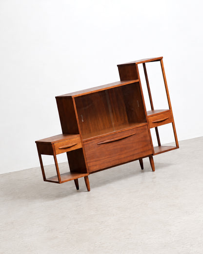 Angled studio view of the full cabinet showing its stepped, asymmetrical silhouette against a white background.