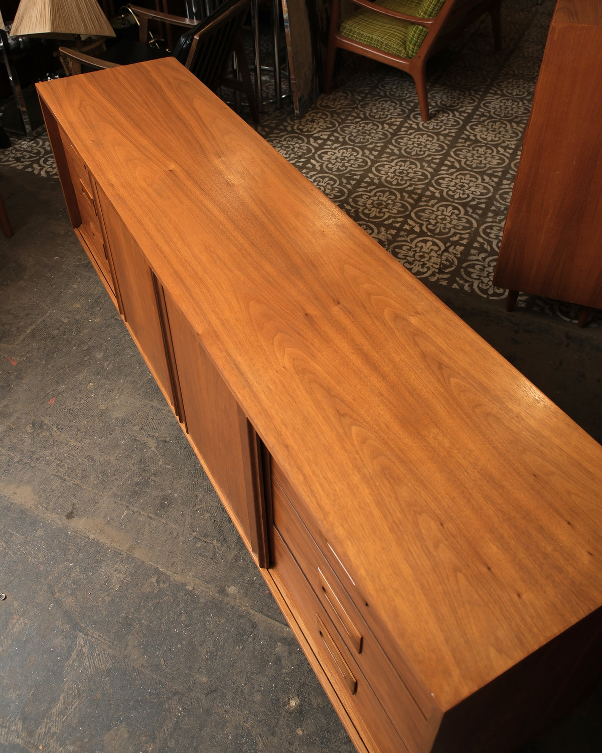 Top-down view showing the walnut grain pattern across the sideboard's surface and drawer fronts.