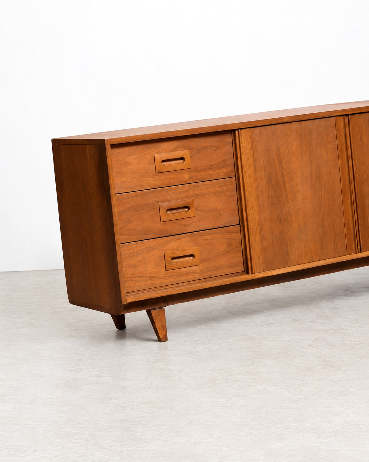 Additional angle of the sideboard showing the full length and tapered leg detail.
