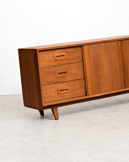 Additional angle of the sideboard showing the full length and tapered leg detail.
