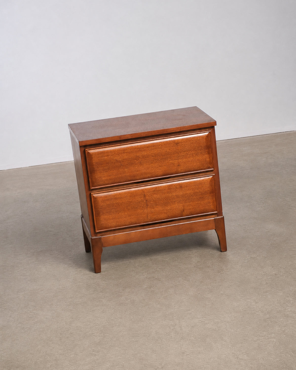 Close-up of the drawer pulls and joinery on a walnut nightstand.