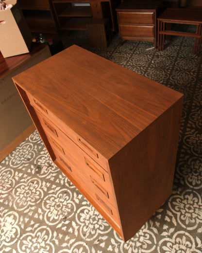 Overhead view showing the walnut grain of the top surface and the depth of the dresser case.