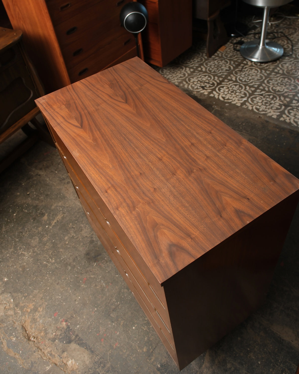 Overhead view of the walnut top grain and side profile of the dresser.