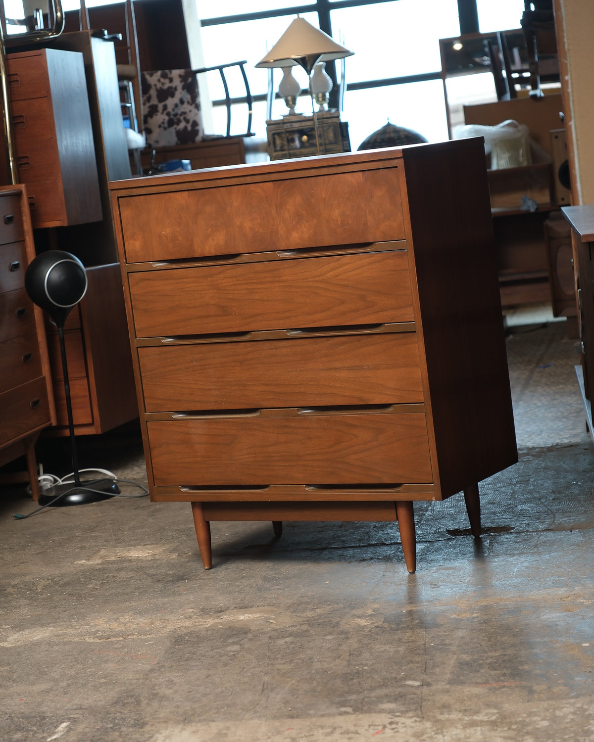 Front view of the dresser showing all four drawers and tapered legs.