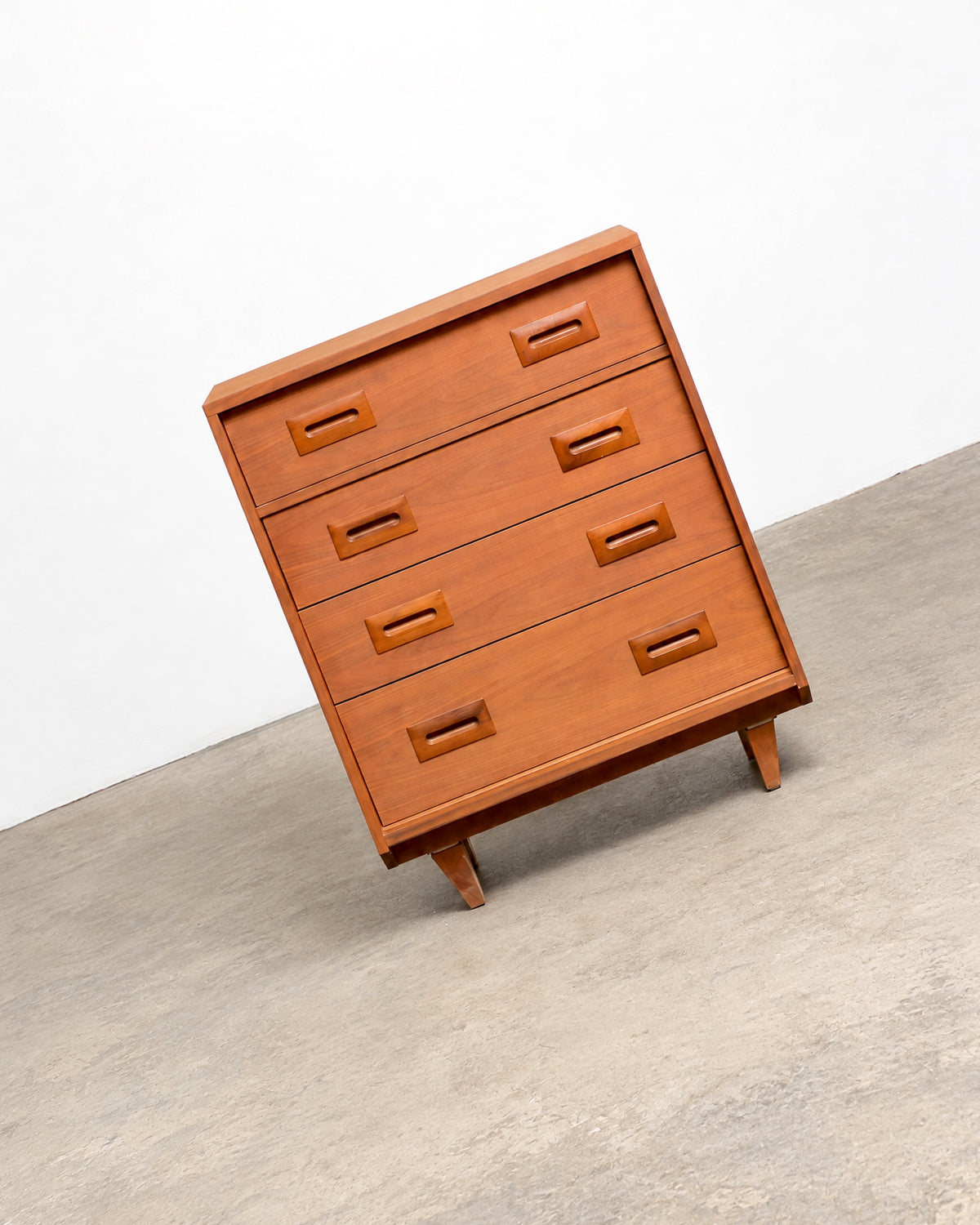 Elevated view of the dresser showing the full drawer front and leg construction.