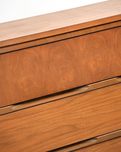 Detail of the recessed drawer pulls and walnut grain pattern.