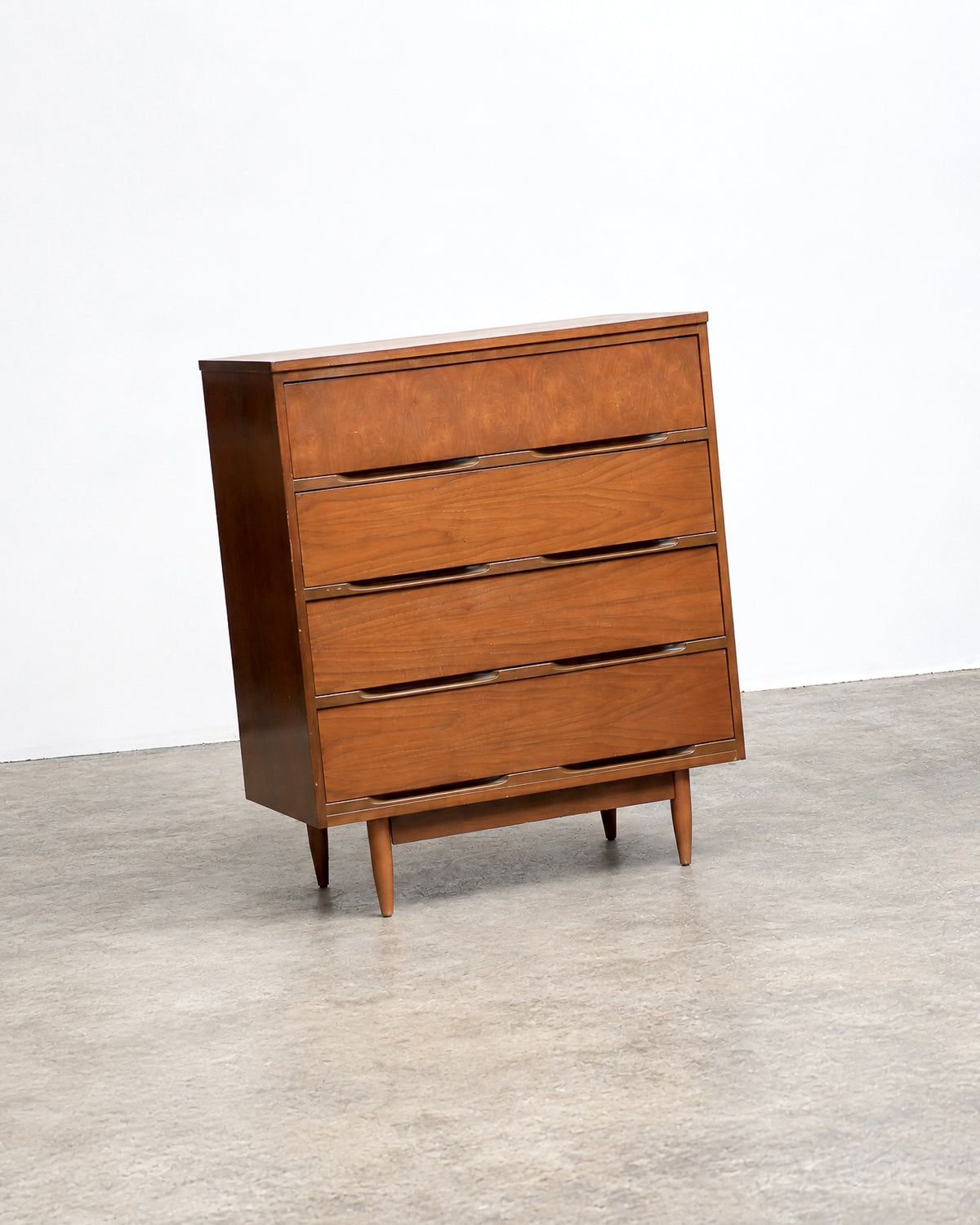 Full view of the dresser in a showroom setting among other vintage pieces.