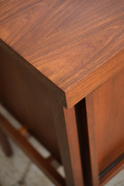 Close-up of the walnut grain and corner joinery on the top of the cabinet