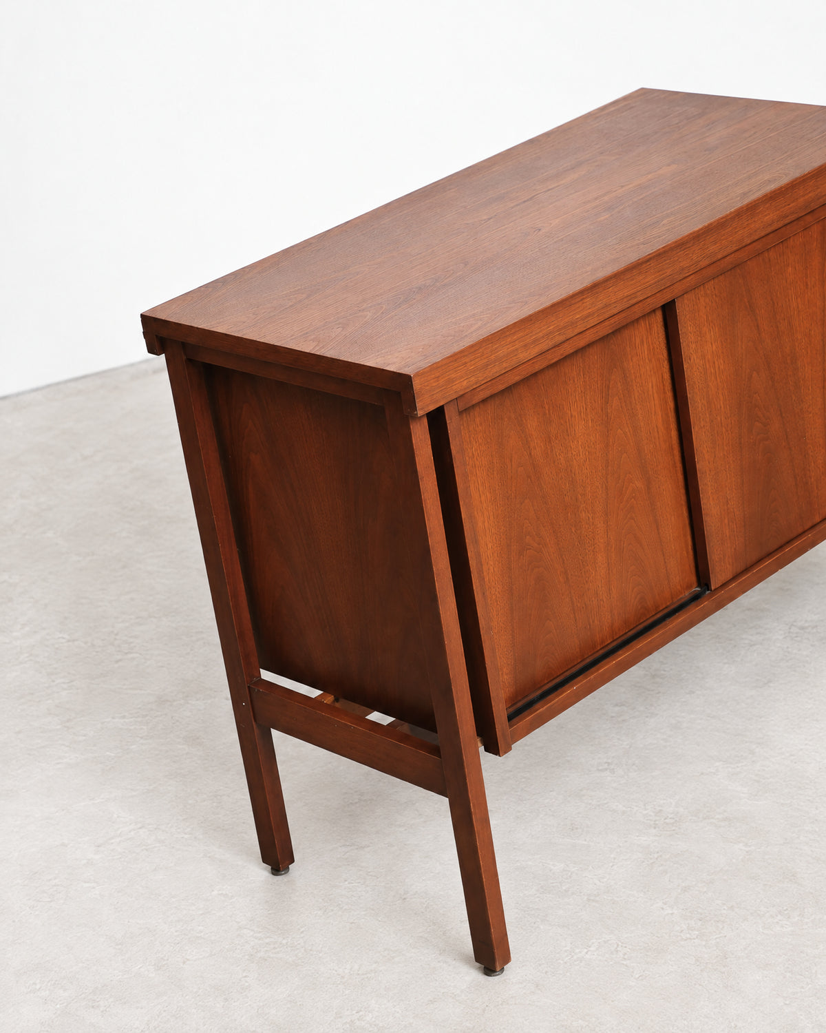 Close-up of the walnut grain and corner joinery on the top of the cabinet