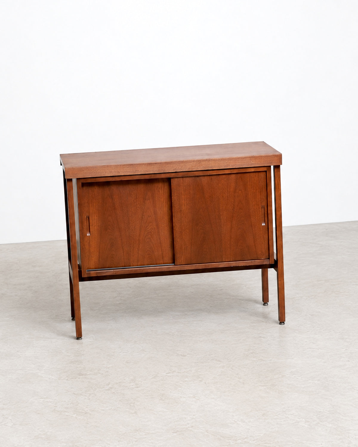 Close-up of the walnut grain and corner joinery on the top of the cabinet