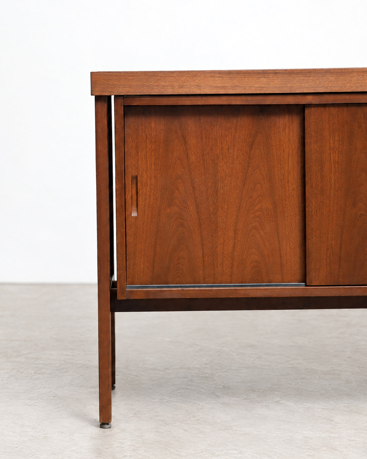 Close-up of the walnut grain and corner joinery on the top of the cabinet
