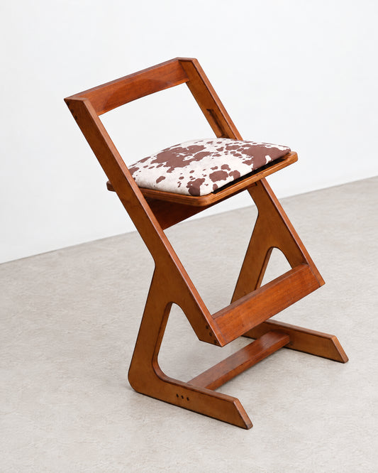Three-quarter angle view of the chair on a plain background, showing its full sculptural silhouette.
