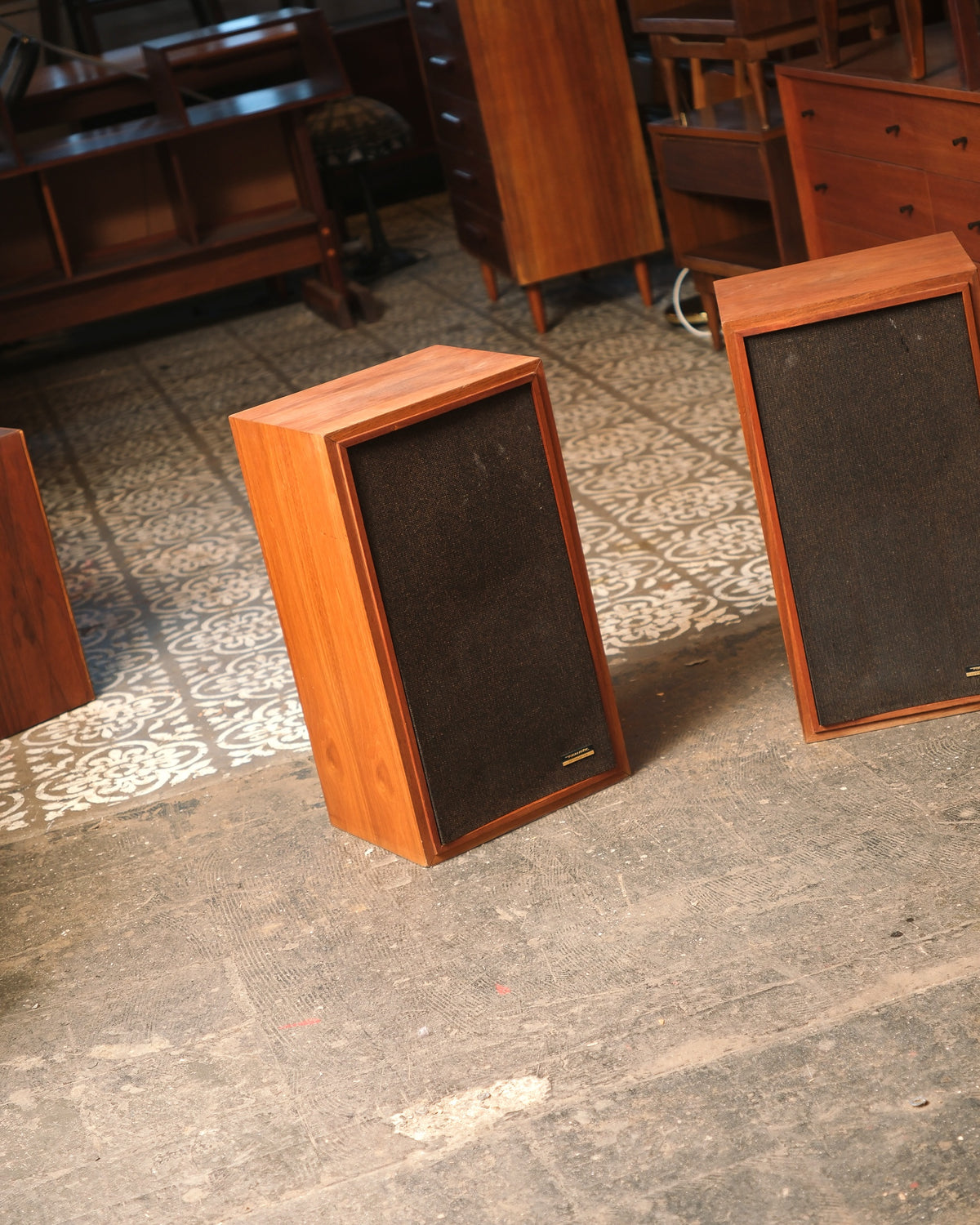Front view of both speakers with grilles on, standing side by side.